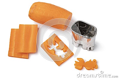 Cutting out goldfishes from fresh raw sweet winter carrots with a mold Stock Photo