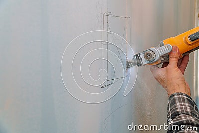 Cutting plasterboard plaster hand with electro saw Stock Photo