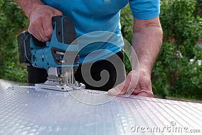 Cutting polycarbonate sheet by cutting machine jigsaw Stock Photo