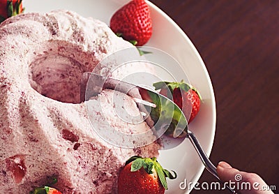 Cutting a Strawberry Charlotte or Mousse Cake Stock Photo