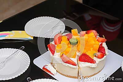 Cutting strawberry & mango birthday cake Stock Photo