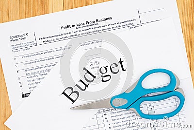 Cutting your monthly budget of your business expenses with the cut word budget Stock Photo