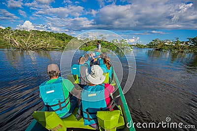 CUYABENO, ECUADOR - NOVEMBER 16, 2016: Unidentified people travelling by boat into the depth of Amazon Jungle in Editorial Stock Photo