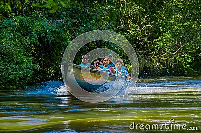 CUYABENO, ECUADOR - NOVEMBER 16, 2016: Unidentified people travelling by boat into the depth of Amazon Jungle in Editorial Stock Photo