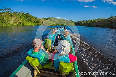 CUYABENO, ECUADOR - NOVEMBER 16, 2016: Unidentified people travelling by boat into the depth of Amazon Jungle in Editorial Stock Photo