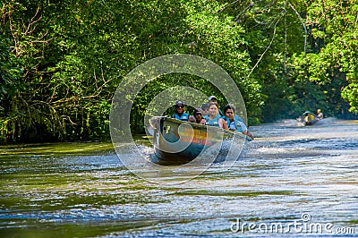 CUYABENO, ECUADOR - NOVEMBER 16, 2016: Unidentified people travelling by boat into the depth of Amazon Jungle in Editorial Stock Photo