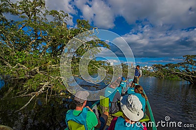 CUYABENO, ECUADOR - NOVEMBER 16, 2016: Unidentified people travelling by boat into the depth of Amazon Jungle in Editorial Stock Photo