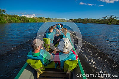 CUYABENO, ECUADOR - NOVEMBER 16, 2016: Unidentified people travelling by boat into the depth of Amazon Jungle in Editorial Stock Photo