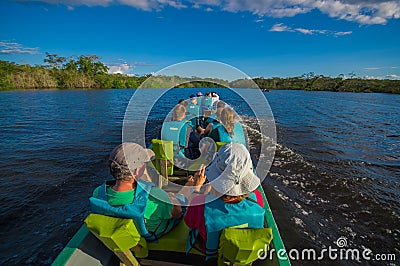 CUYABENO, ECUADOR - NOVEMBER 16, 2016: Unidentified people travelling by boat into the depth of Amazon Jungle in Editorial Stock Photo