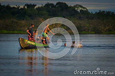 CUYABENO, ECUADOR - NOVEMBER 16, 2016: Young Tourists Jumping Into The Lagoon Grande Against The Sunset, Cuyabeno Editorial Stock Photo