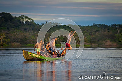 CUYABENO, ECUADOR - NOVEMBER 16, 2016: Young Tourists Jumping Into The Lagoon Grande Against The Sunset, Cuyabeno Editorial Stock Photo