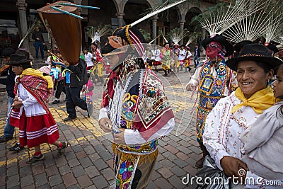 A group of people wearing traditional clothes and masks during the Huaylia on Christmas day at the Plaza de Armas square in the ci Editorial Stock Photo