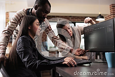 Cyber security agency multiethnic team encrypting mainframe database Stock Photo
