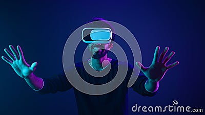 Cyber space gamer male Arabian man in VR glasses excited playing experience metaverse virtual reality cyberspace gaming Stock Photo