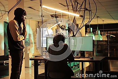 Cyberattack, criminals team coding computer virus program Stock Photo