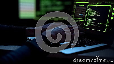 Cybercriminal creating malicious software, typing on laptop keypad, closeup Stock Photo