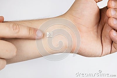 The man shows his hand with a chip implanted. The concept of chipping and implantation of electronic technologies into the human Stock Photo