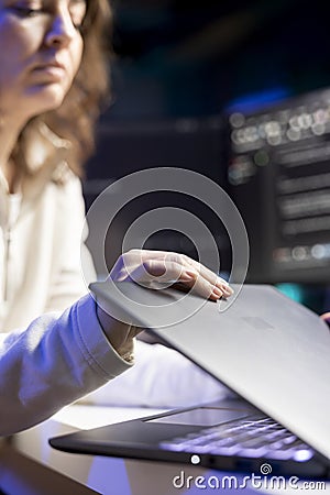 Programmer installing fortified code on notebook device Stock Photo