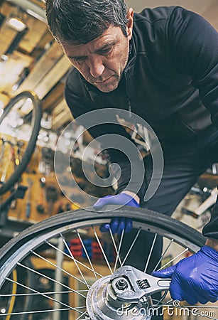 Cycle mechanist working on bike maintenance in workshop Stock Photo