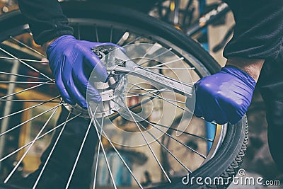 Cycle mechanist working on bike tires in workshop Stock Photo