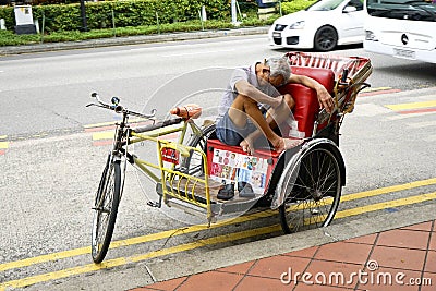 Cycle Rickshaw driver having a rest Editorial Stock Photo