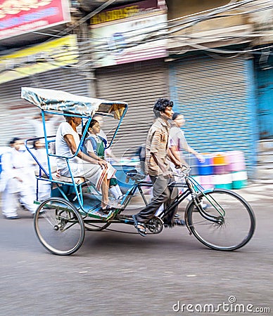 Cycle rickshaw transports passenger in Delhi, India Editorial Stock Photo