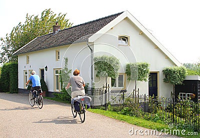 Energetic couple cycles at the dike,Betuwe area,NL Editorial Stock Photo