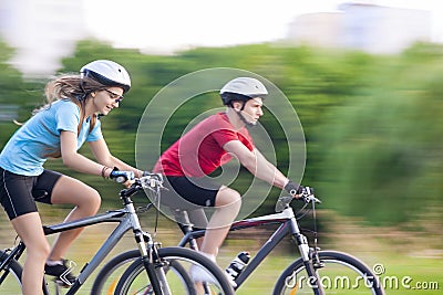 Cycling Concept: Young Caucasian Couple on Speedy Trip Stock Photo