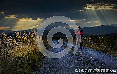 Cycling woman riding on bike in autumn mountains forest landscape. Woman cycling MTB gravel road trail track. Outdoor sport Stock Photo