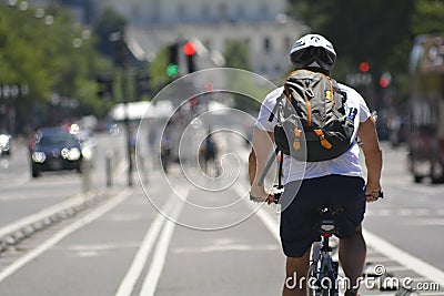 Cyclist with backpack on city street Editorial Stock Photo