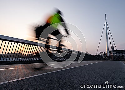 Cyclist on a bicycle bridge in Odense, Denmark Stock Photo