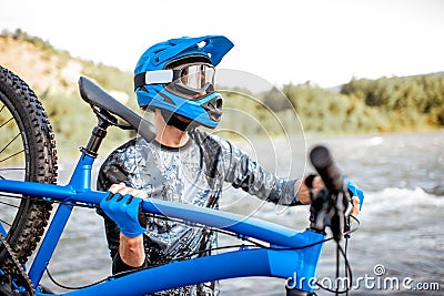 Cyclist with bicycle on the mountains Stock Photo