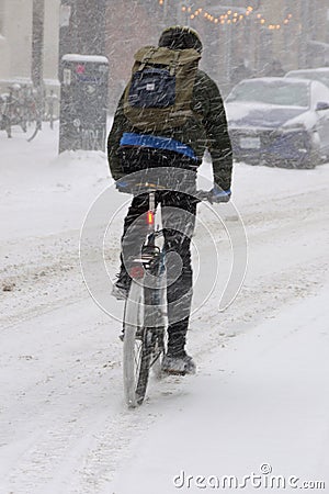 A cyclist in winter snow Stock Photo