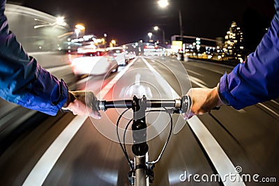 Cyclist drives on the bike path past the traffic jam Stock Photo