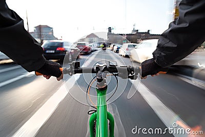 Cyclist drives on the bike path past the traffic jam - First-person view of cyclist Stock Photo