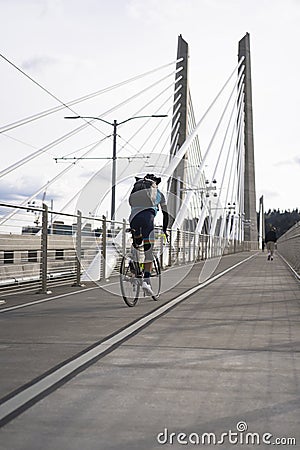 Cyclist on road bike is riding Tilikum Crossing Bridge Editorial Stock Photo