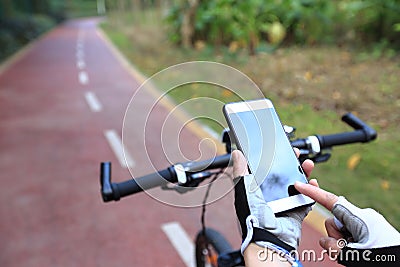 Cyclist hands use gps navigator on smartphone Stock Photo