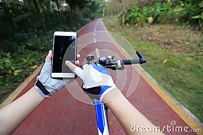 Cyclist hands use gps navigator on smartphone Stock Photo