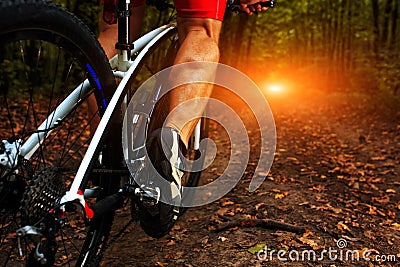 Cyclist man legs riding mountain bike Stock Photo