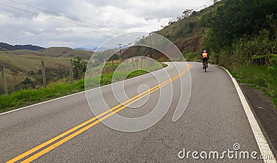 Cyclist pedaling on dual paved road. bike on the road, speed on the bike Stock Photo