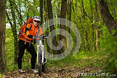 Cyclist Riding the Bike on a Trail in Summer Forest Stock Photo