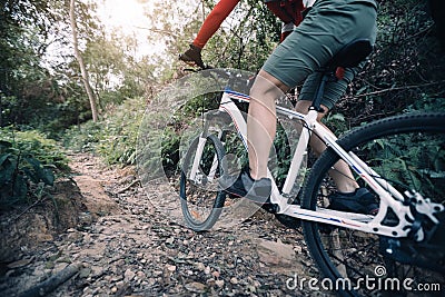 Cyclist riding mountain bike on rocky trail Stock Photo