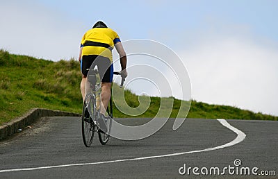 Cyclist riding uphill Stock Photo