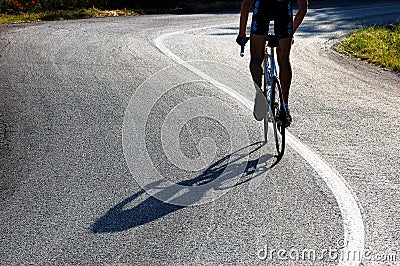 Cyclist riding uphill Stock Photo