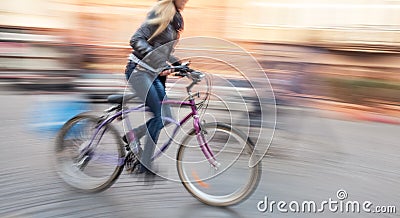 Cyclist in traffic on the city roadway Stock Photo