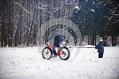 Cyclist in winter on a bicycle with very wide wheels 2018 Stock Photo