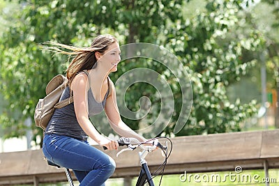 Cyclist woman riding bicycle in a park Stock Photo