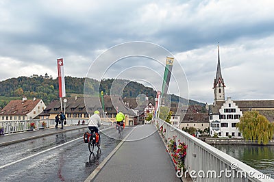 Cyclists cycling on Rhine River Bridge in Stein Am Rhein, an old town on River Rhine in Schaffhausen, Switzerland Editorial Stock Photo