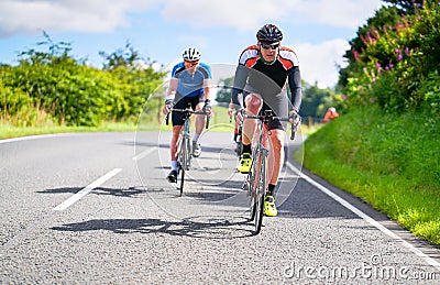 Cyclists racing on country roads Stock Photo