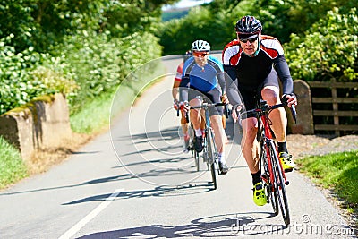 Cyclists racing on country roads Stock Photo